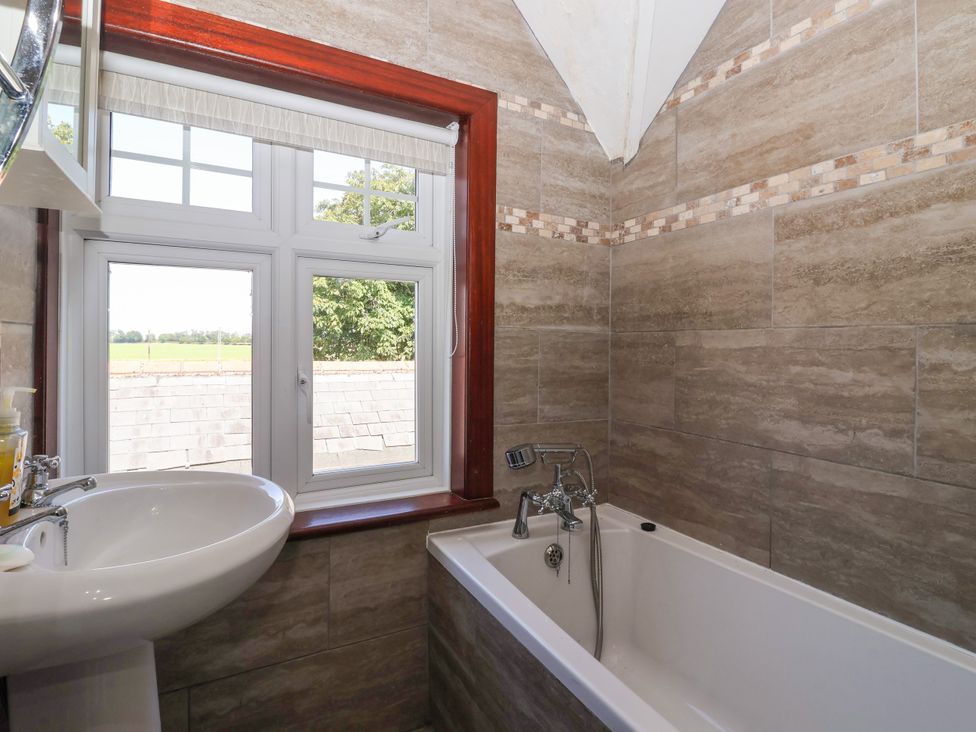 A bathroom with a sink and bathtub at The Old Post Office 