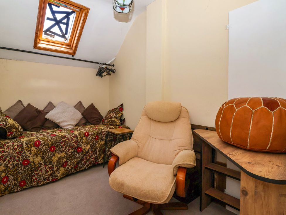A snug with a sofa, chair, and table at The Old Post Office 