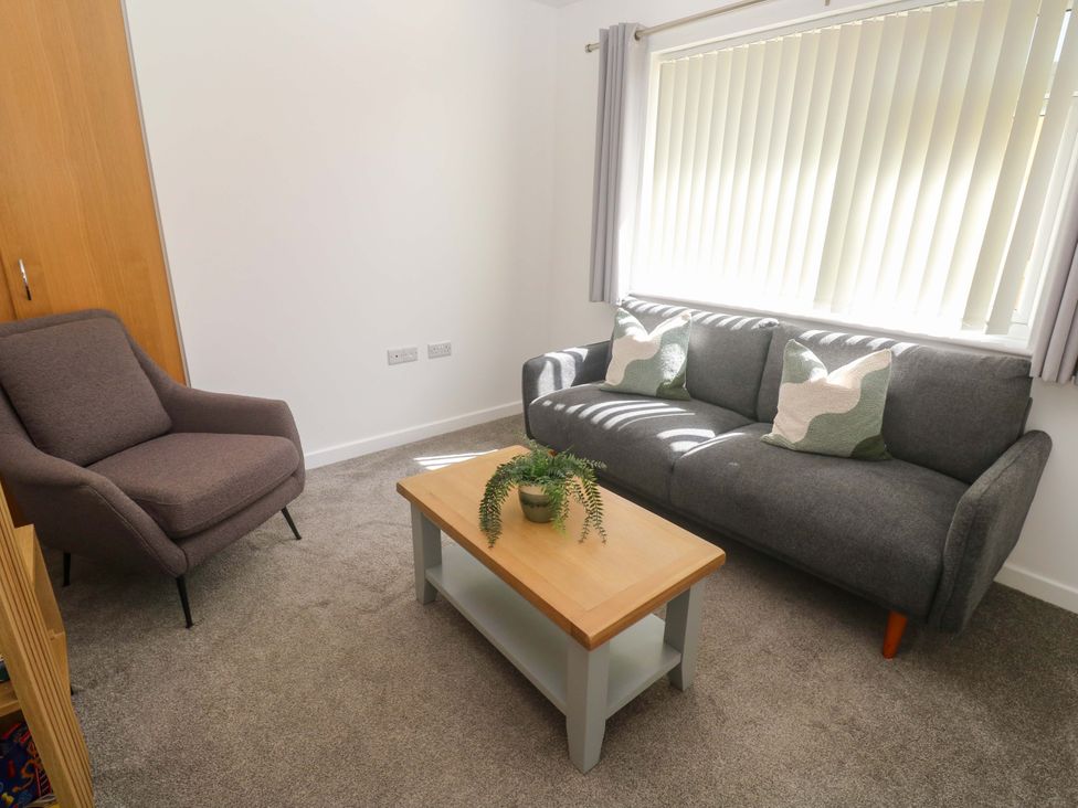 A living room with a sofa and armchair at Agan Paradhis in Quintrell Downs
