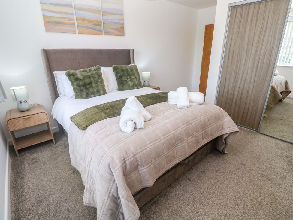 A bedroom with a bed and bedside table at Agan Paradhis in Quintrell Downs