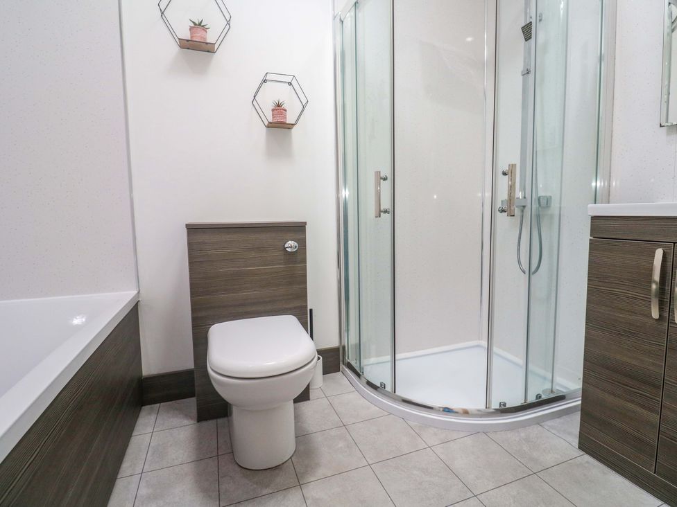 A bathroom with a shower and toilet at Agan Paradhis in Quintrell Downs