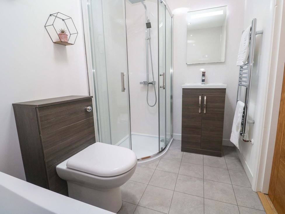 A bathroom with a shower and toilet at Agan Paradhis in Quintrell Downs