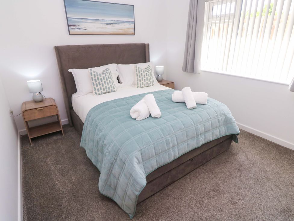 A bedroom with a bed and bedside table at Agan Paradhis in Quintrell Downs