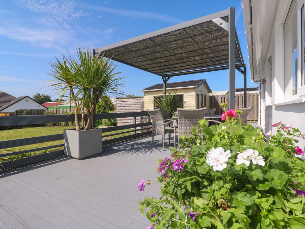 An outdoor area with a canopy and seating at Agan Paradhis in Quintrell Downs