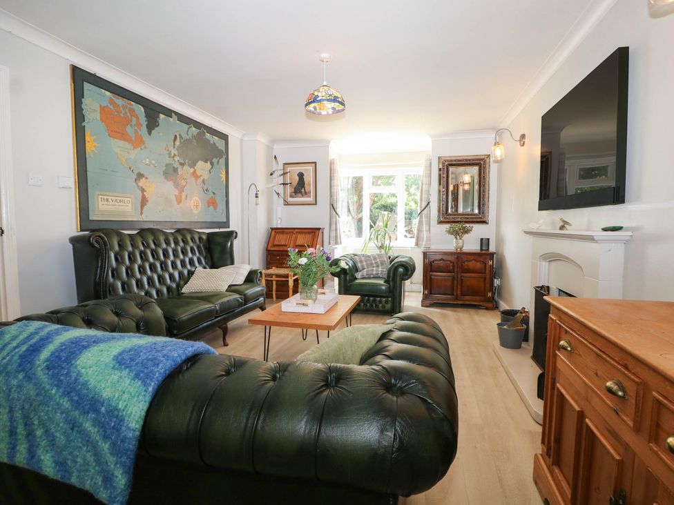 A living room with a map on the wall and a coffee table at Taliesin in Hailsham