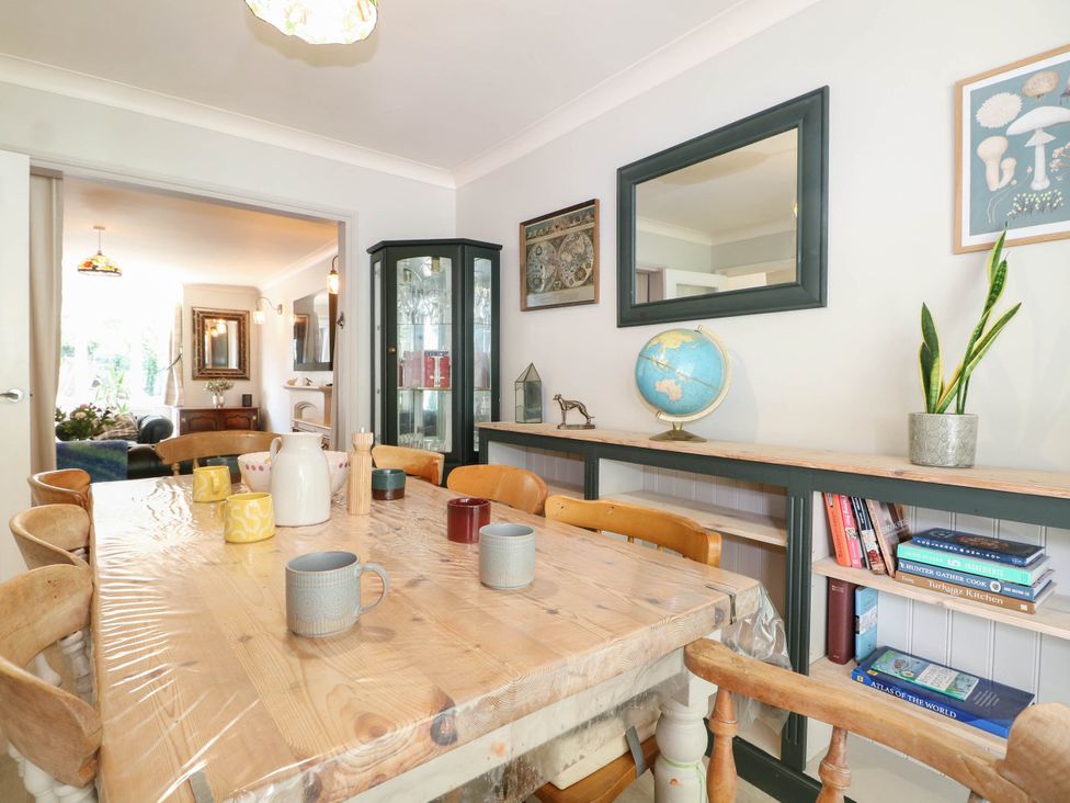 A dining room featuring a wooden table and chairs at Taliesin in Hailsham