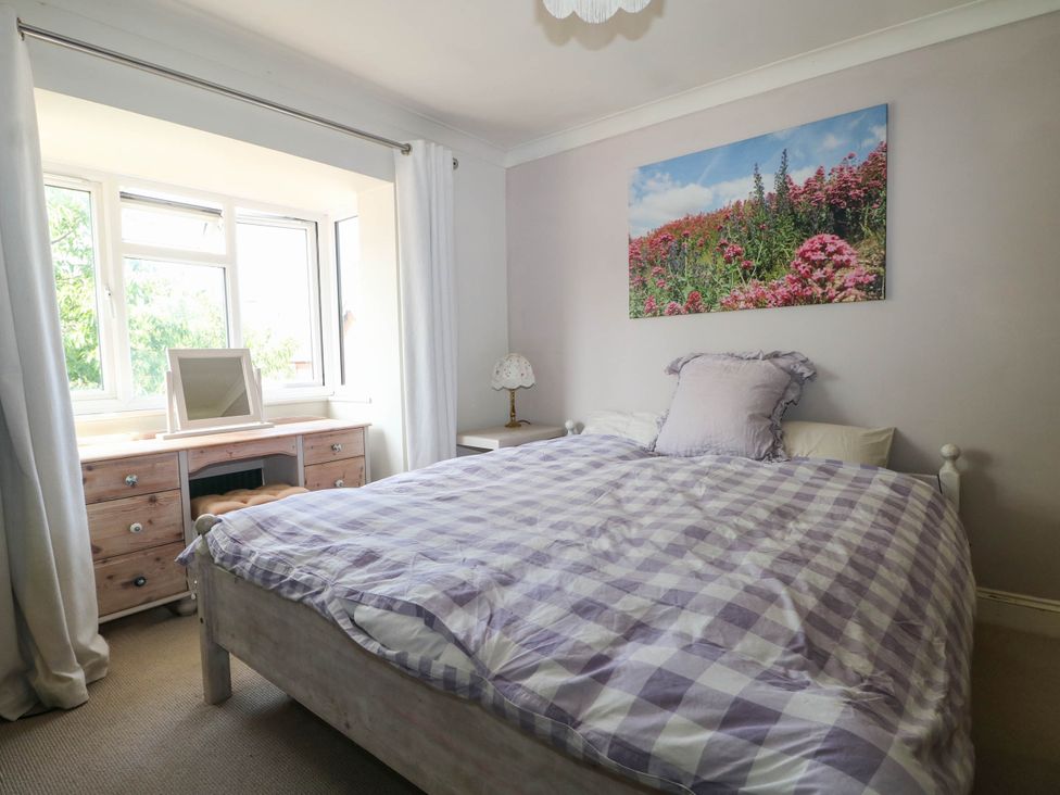 A bedroom with a bed and desk at Taliesin in Hailsham