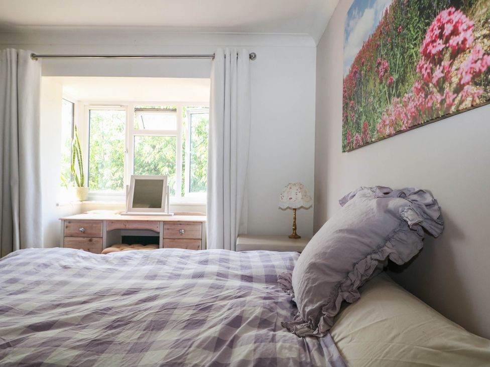 A bedroom with a bed and desk at Taliesin in Hailsham