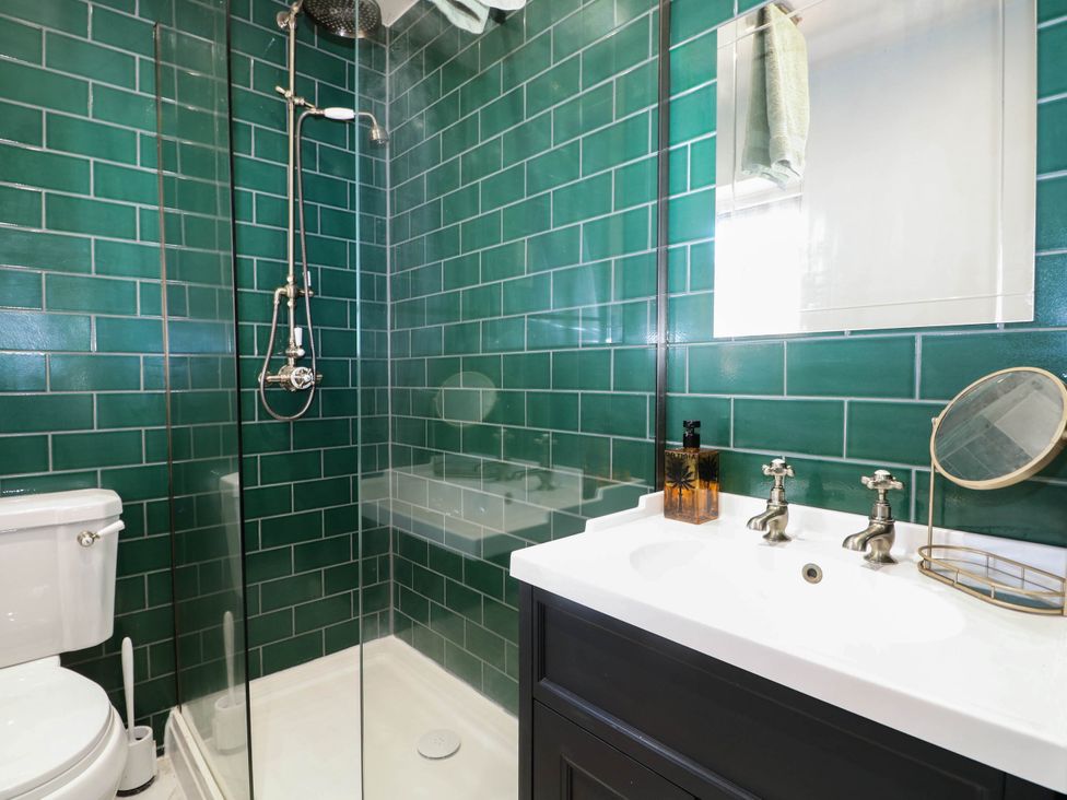 A bathroom with a shower and sink at Taliesin in Hailsham