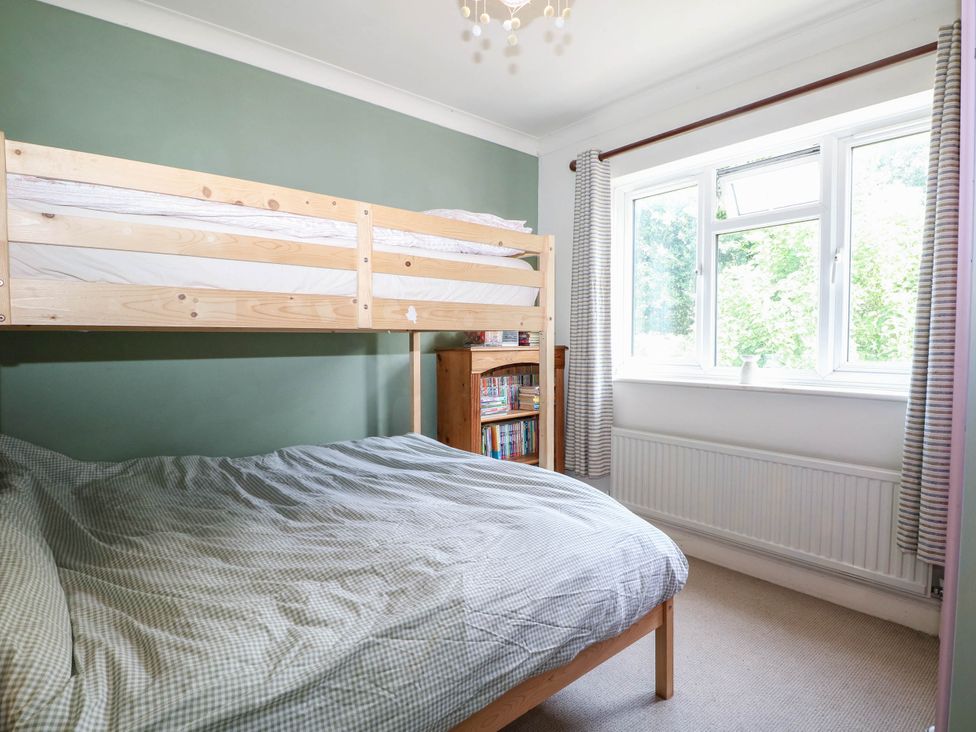 A bedroom with a bunk bed and a window at Taliesin in Hailsham
