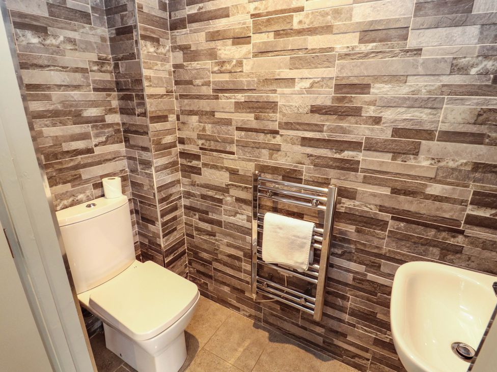 A bathroom with a toilet and sink at 11 The Forge in Brampton