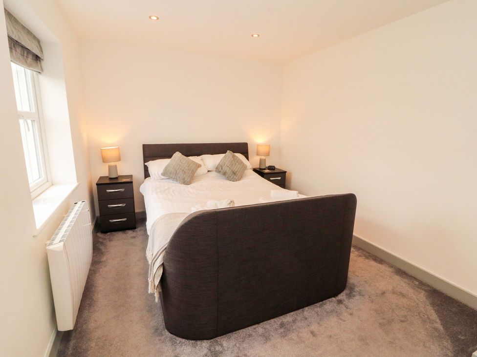 A bedroom with a bed and nightstand at 11 The Forge in Brampton