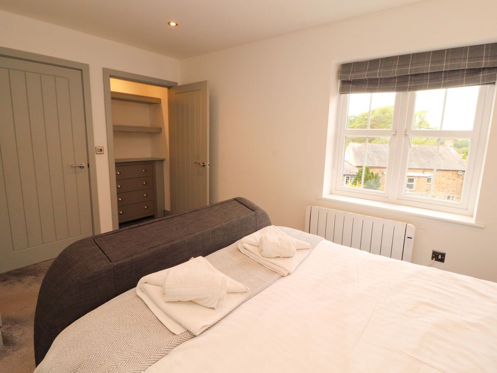A bedroom with a bed and storage furniture at 11 The Forge in Brampton