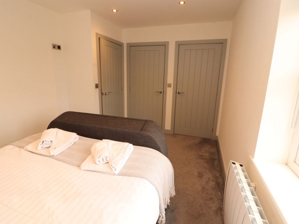 A bedroom with a bed and towels on it at 11 The Forge in Brampton