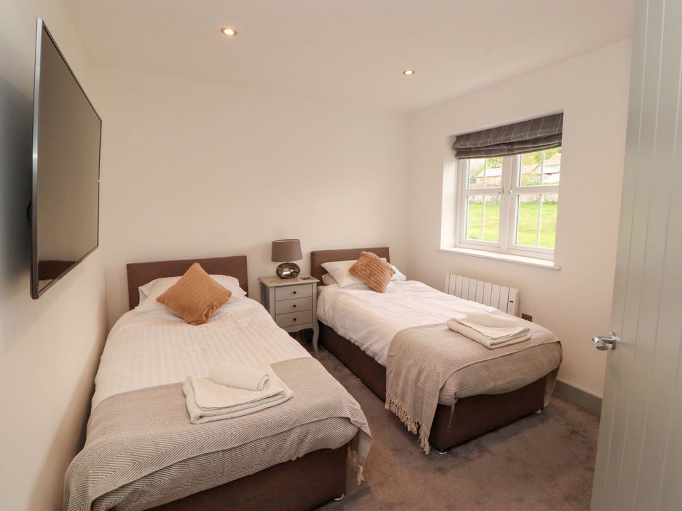 A bedroom with two beds and a television at 11 The Forge Brampton
