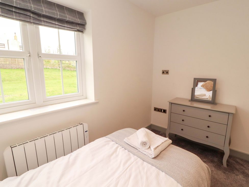 A bedroom with a bed and dresser at 11 The Forge in Brampton