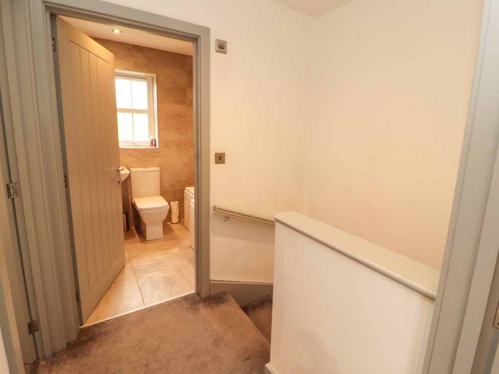 A bathroom with a toilet and sink at 11 The Forge in Brampton