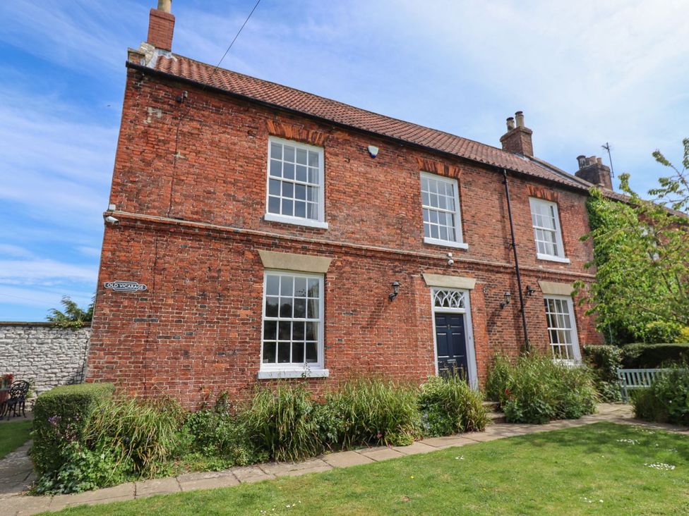 A brick house with garden at Reighton House in Filey
