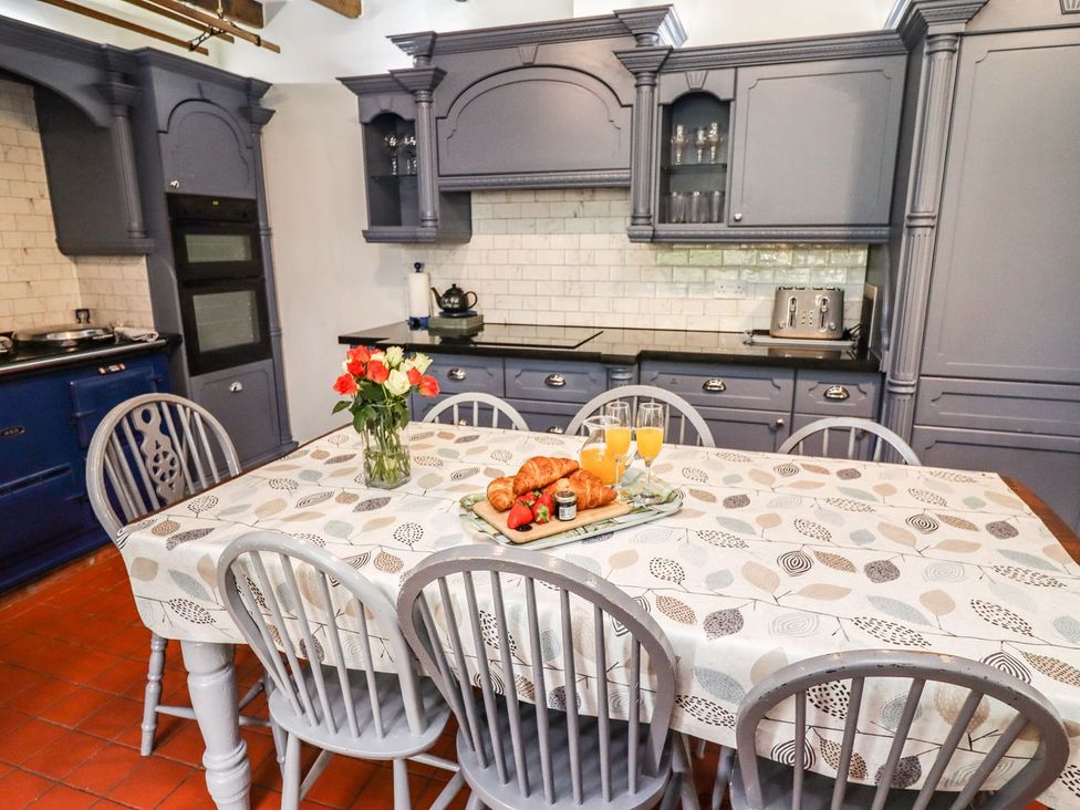 A kitchen with a table set for breakfast at Reighton House in Filey
