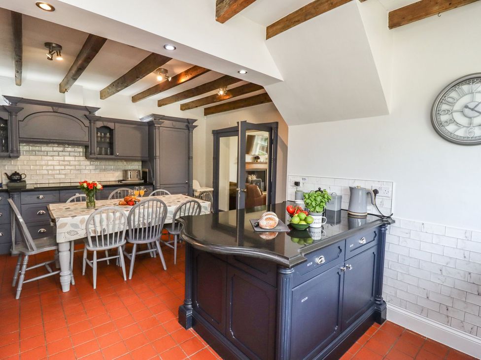 A kitchen with a table and chairs at Reighton House in Filey