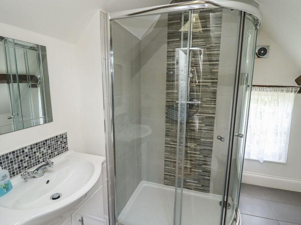 A bathroom with a sink and shower at Reighton House in Filey