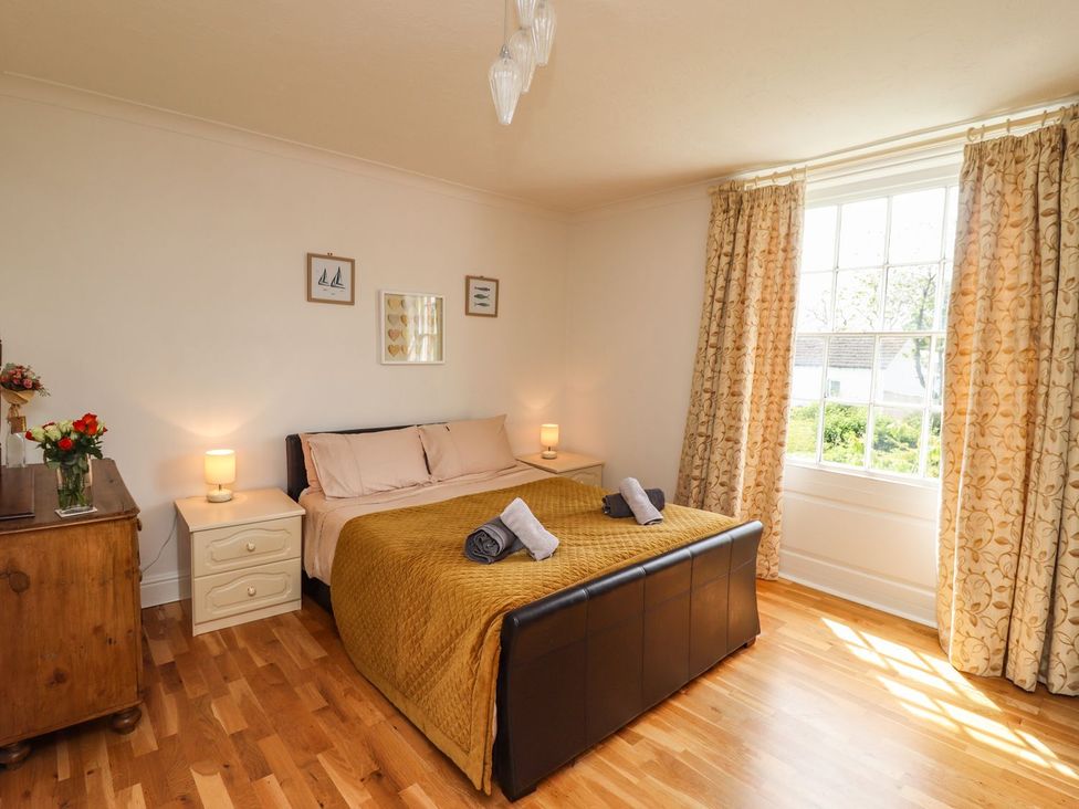 A bedroom with a bed and nightstand at Reighton House in Filey