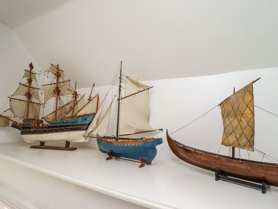Three model ships on a shelf at Reighton House in Filey