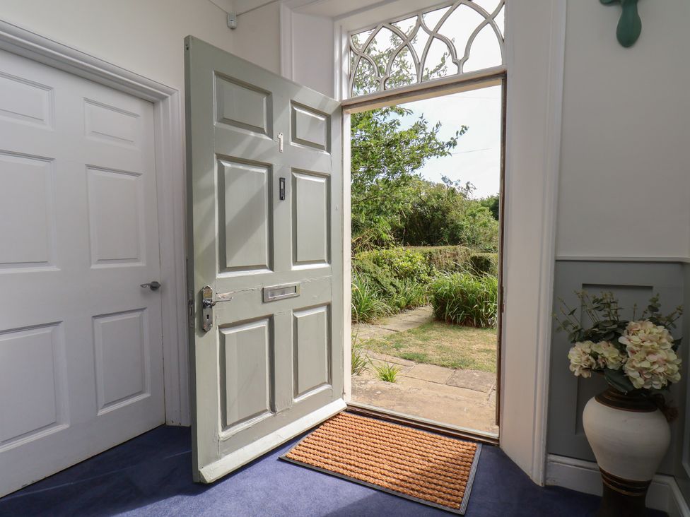 An entrance with an open door and a doormat at Reighton House in Reighton near Filey