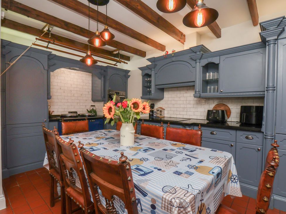 A kitchen with a table and chairs at Reighton House in Reighton near Filey