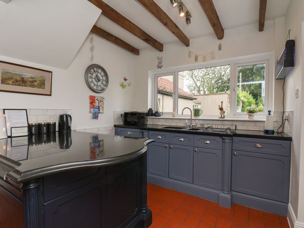 A kitchen with a countertop and cabinets at Reighton House in Reighton near Filey