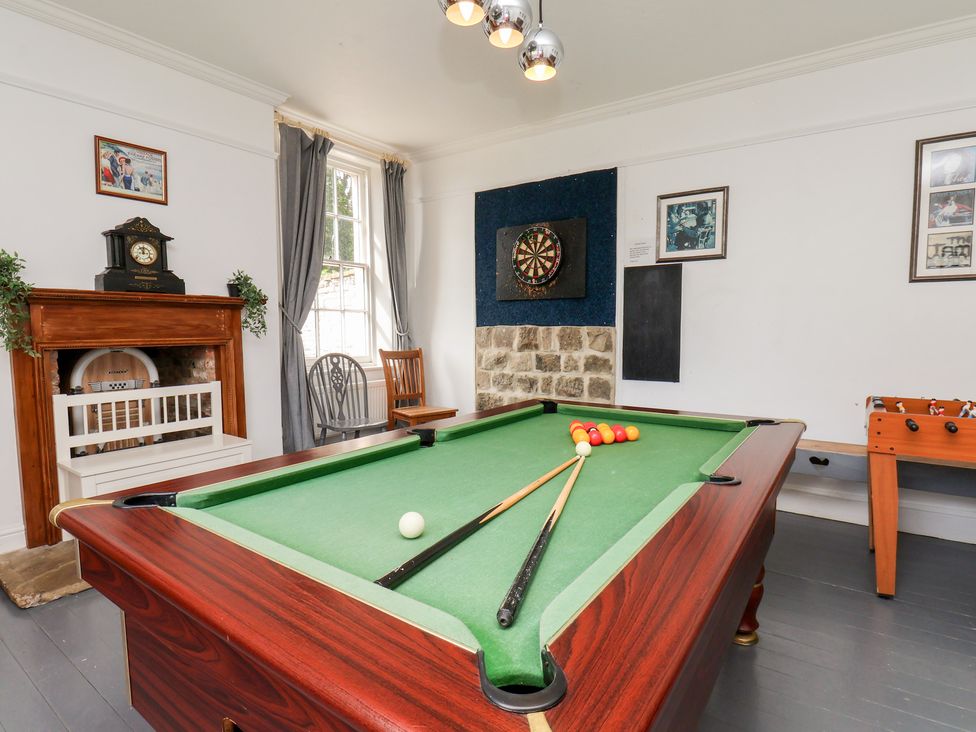 A game room with a pool table and foosball table at Reighton House in Reighton near Filey