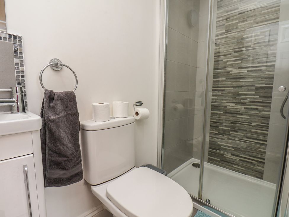 A bathroom with a sink, toilet, and shower at Reighton House in Reighton near Filey