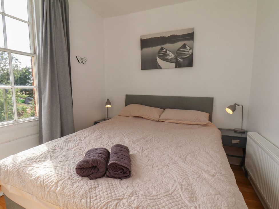 A bedroom with a bed and nightstand at Reighton House in Reighton near Filey
