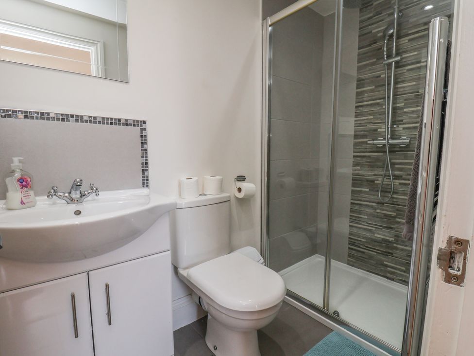 A bathroom with a shower and sink at Reighton House in Reighton near Filey