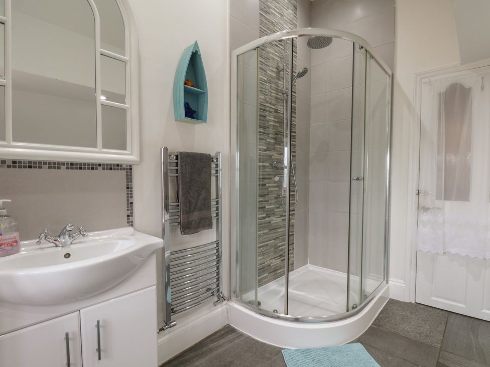 A bathroom with a shower and sink at Reighton House in Reighton near Filey