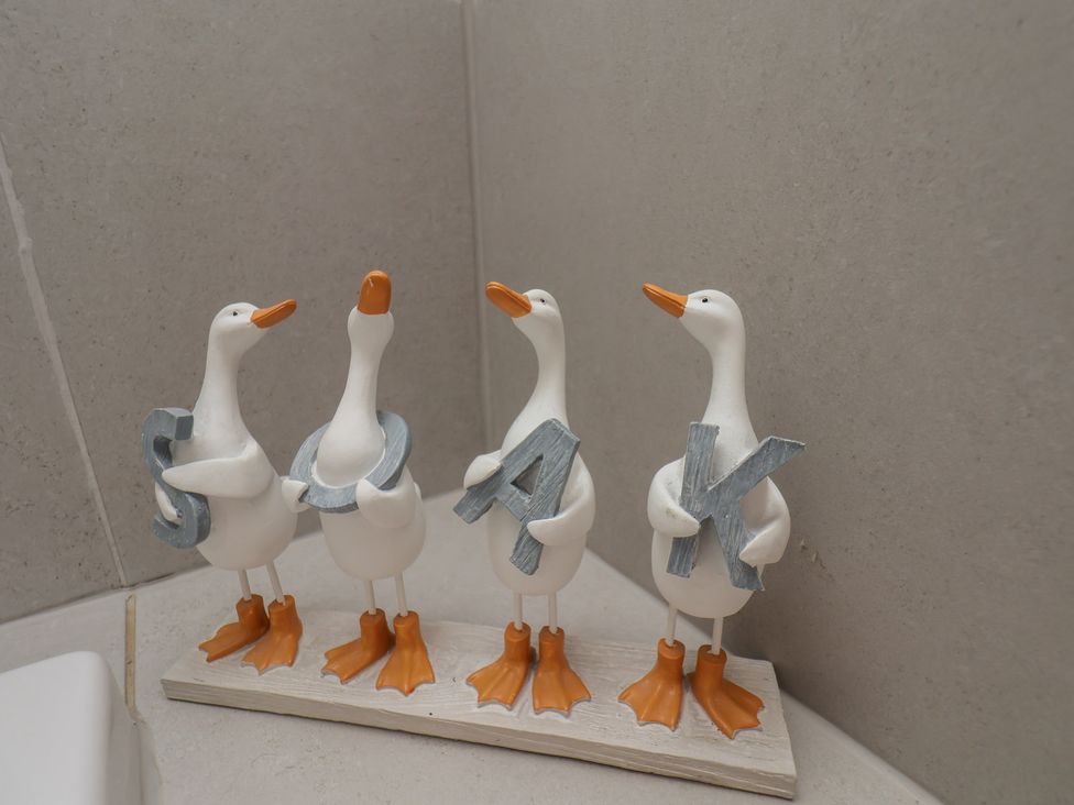 Decorative geese holding letters in a bathroom at Reighton House in Reighton near Filey