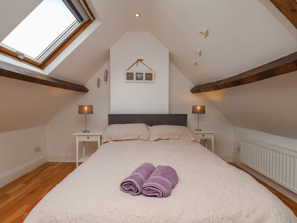 A bedroom with a bed and bedside tables at Reighton House in Reighton near Filey