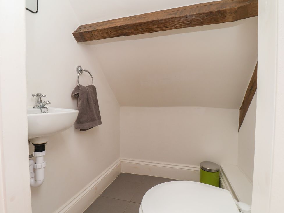 A bathroom with a toilet and sink at Reighton House in Reighton near Filey