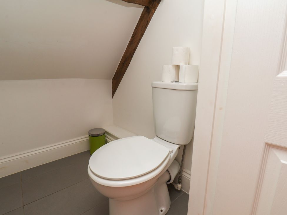 A bathroom with a toilet and toilet rolls at Reighton House, Reighton near Filey