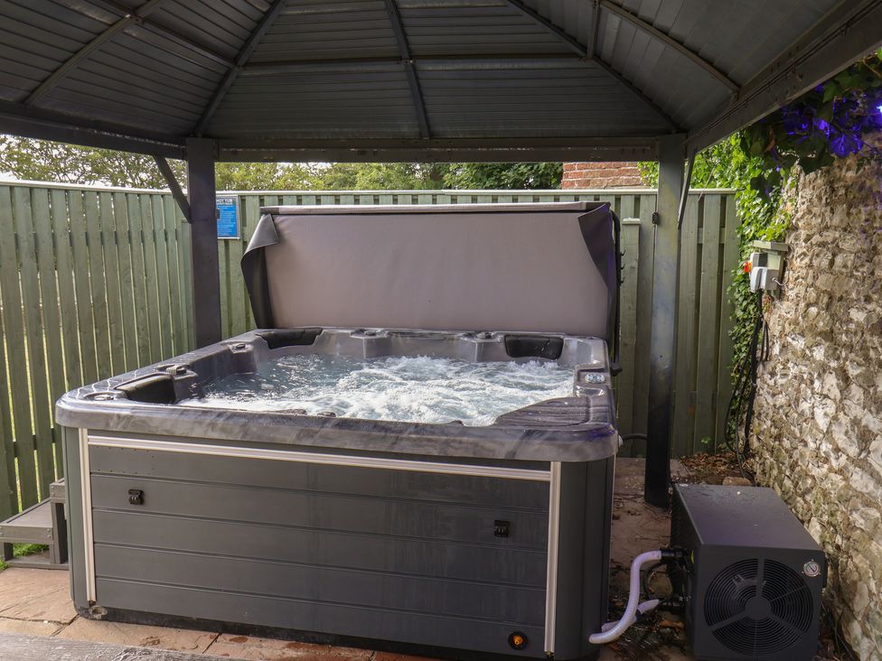 A hot tub under a canopy in an outdoor area at Reighton House near Filey