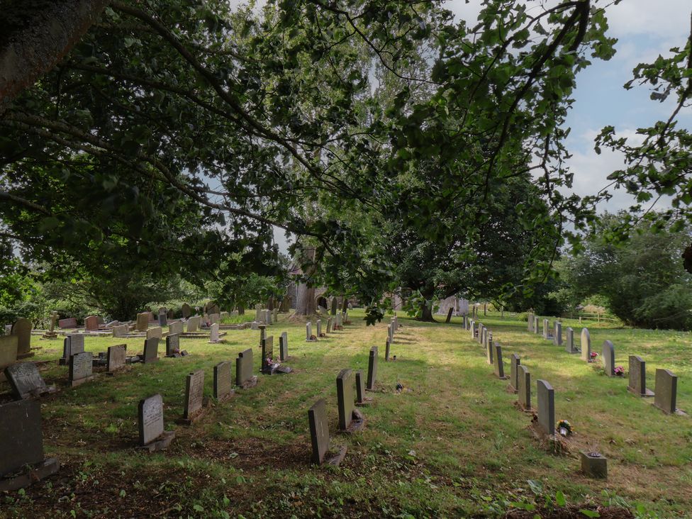 A cemetery with headstones and grass at Reighton House in Reighton near Filey