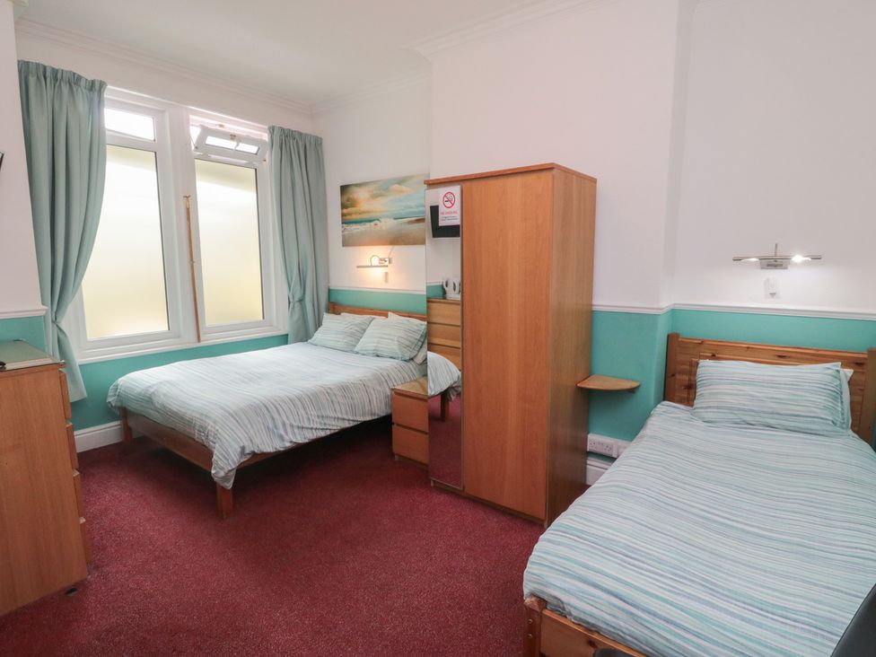 A bedroom with a double bed and a single bed at Meltham Guest House in Scarborough