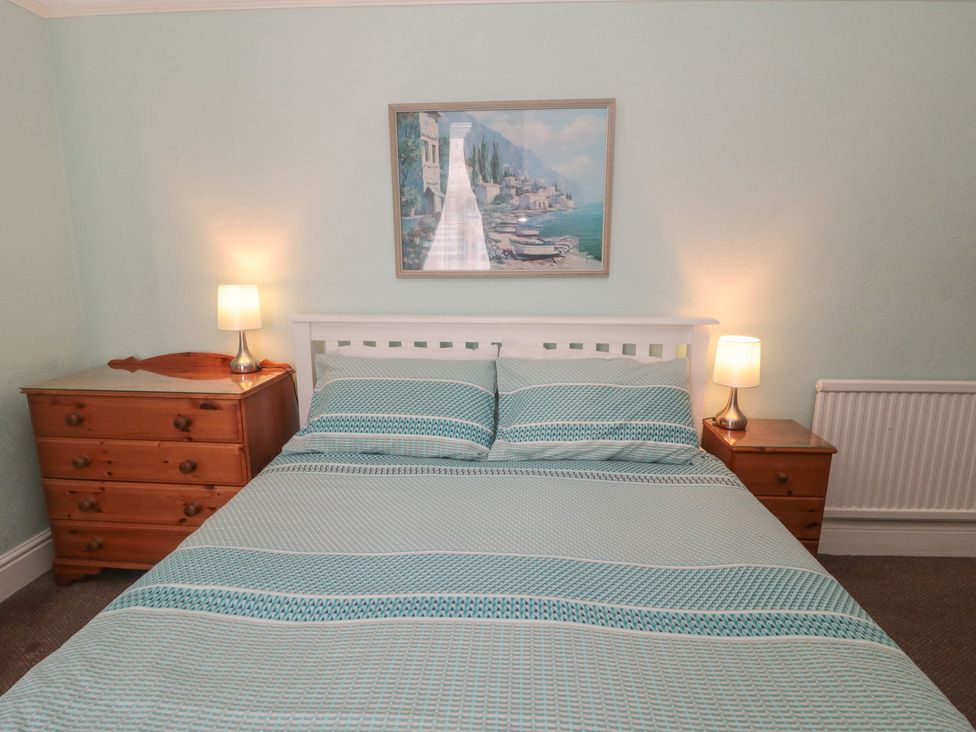 A bedroom with a bed and nightstands at Meltham Guest House in Scarborough