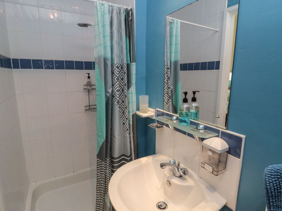 A bathroom with a shower and sink at Meltham Guest House in Scarborough