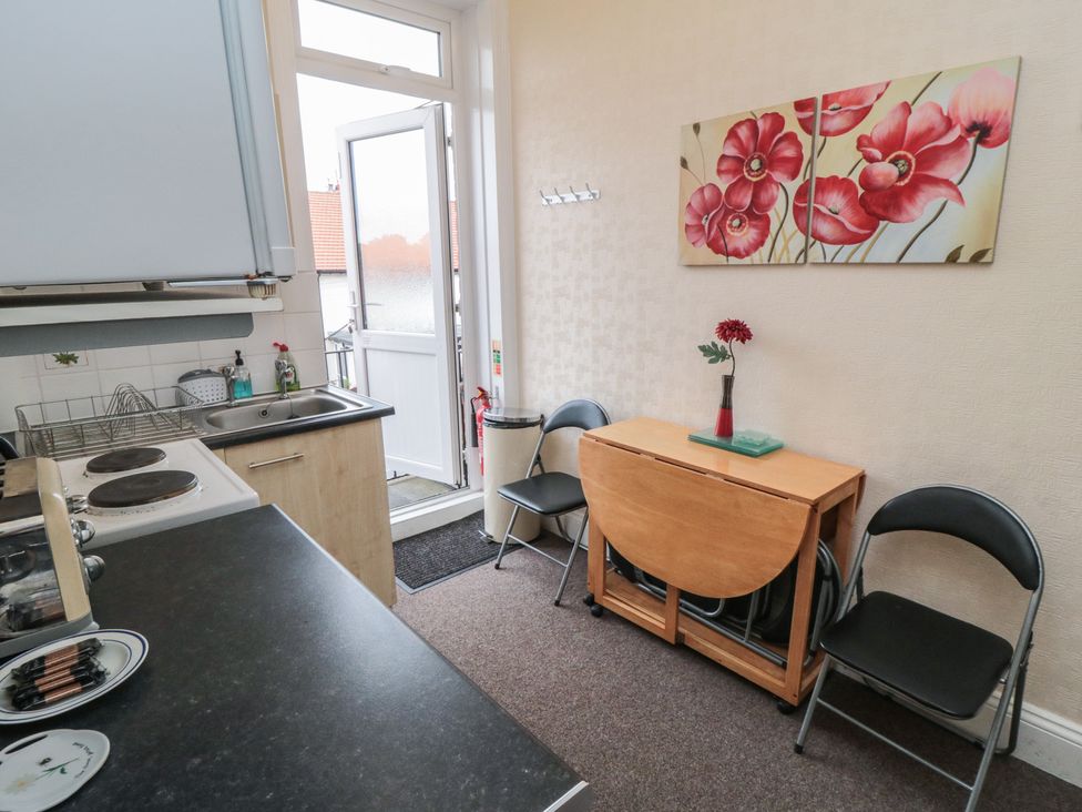 A kitchen with a sink and cooking facilities at Meltham Guest House in Scarborough