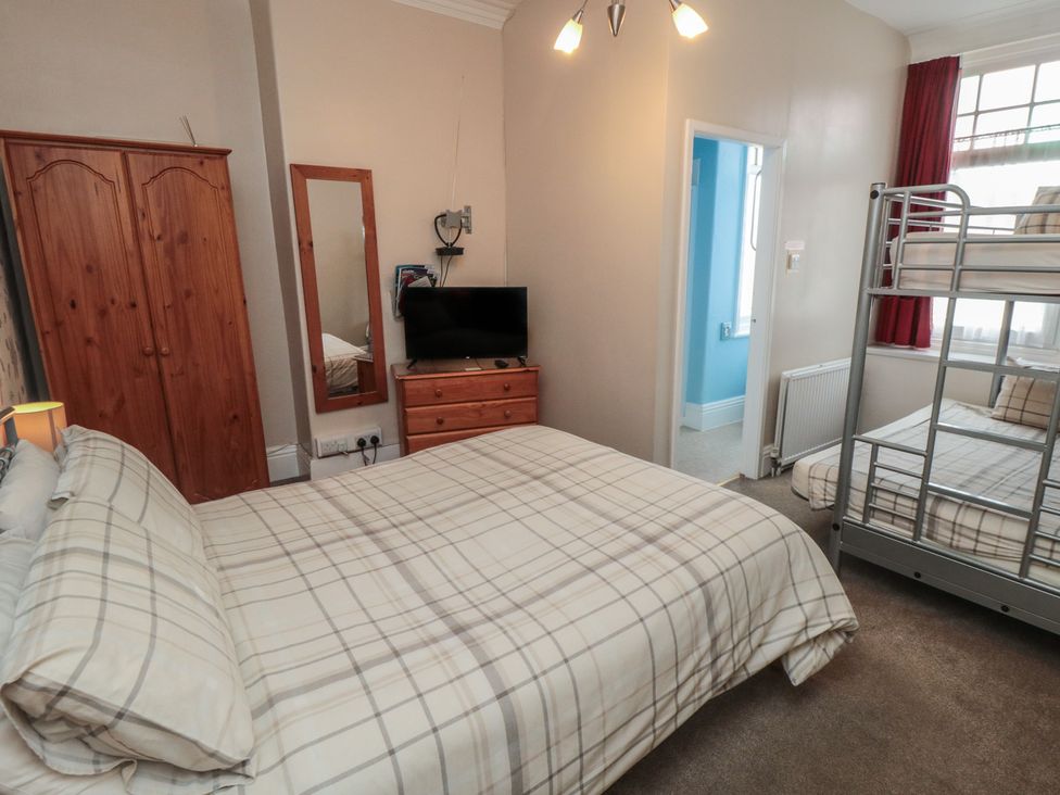 A bedroom with a bed and bunk bed at Meltham Guest House in Scarborough