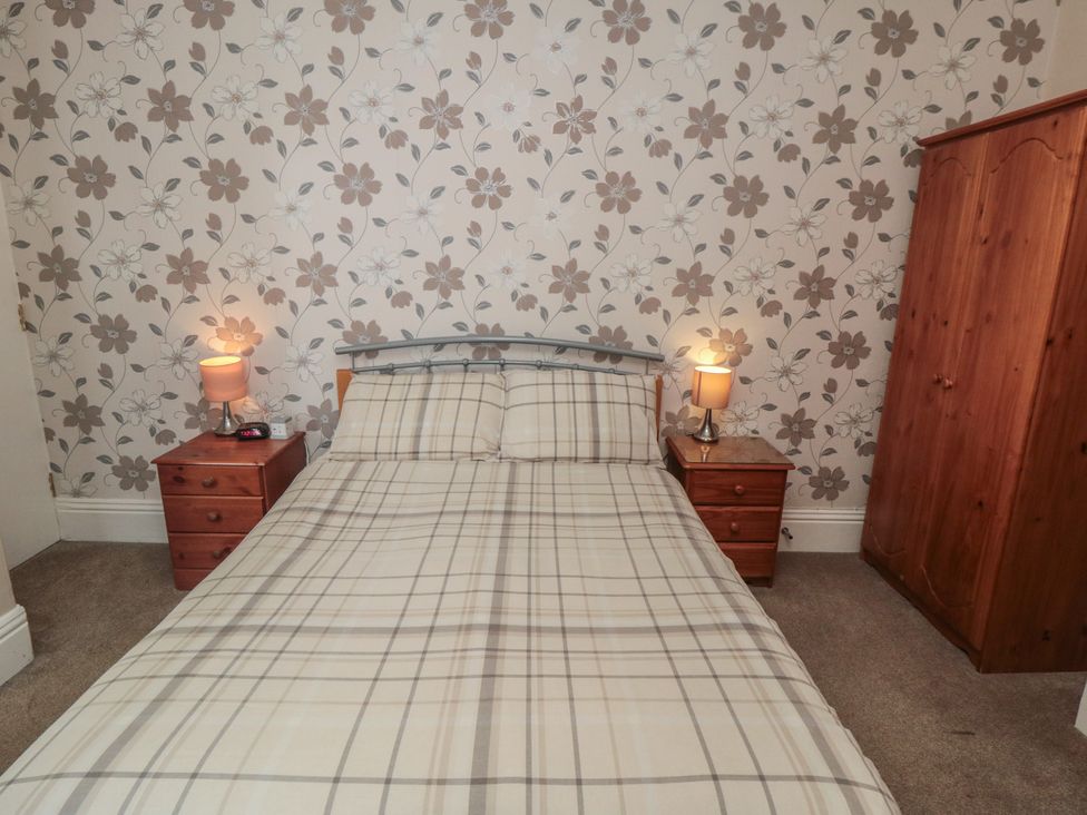 A bedroom with a bed and nightstands at Meltham Guest House in Scarborough