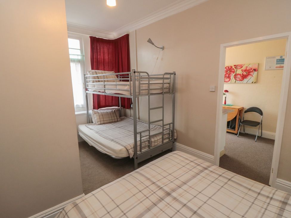 A bedroom with a bunk bed and double bed at Meltham Guest House in Scarborough