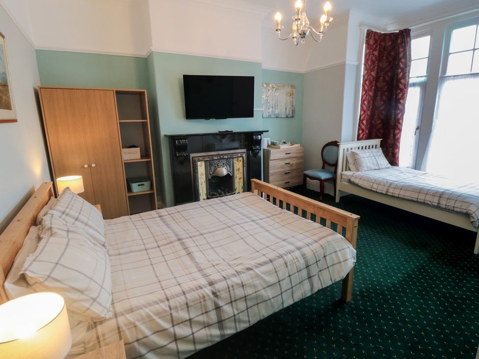 A bedroom with a double bed and single bed at Meltham Guest House in Scarborough