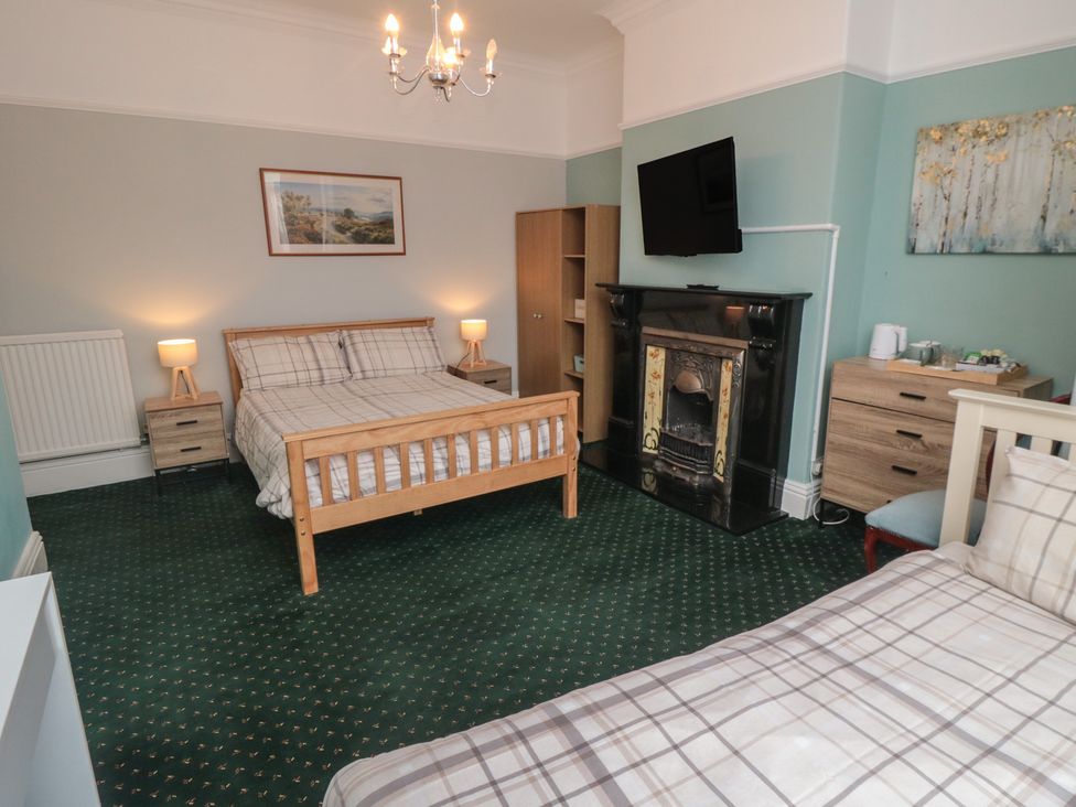 A bedroom with a bed and desk at Meltham Guest House in Scarborough
